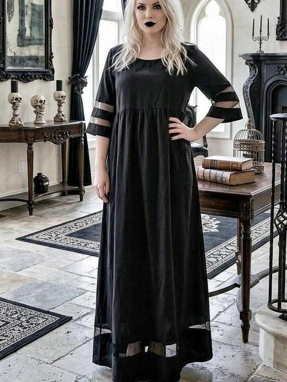 Black maxi dress with sheer sleeves and cutouts. Size: XXL